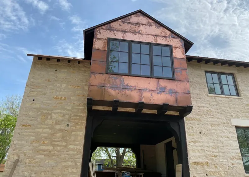 Copper metal panel facade on a stone building for Skylight Installation in Atmore